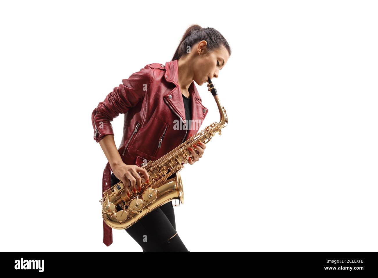Young female musician in a leather jacket playing a saxophone isolated on white background Stock Photo