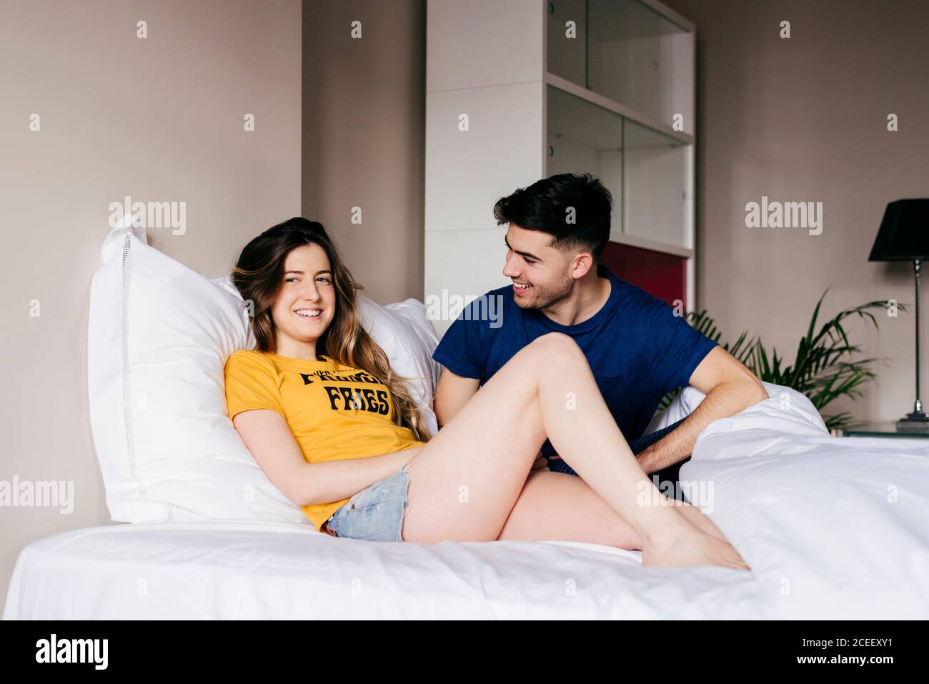 Smiling couple lying in bed Stock Photo