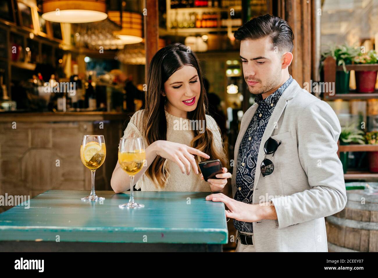 Couple sitting at table in outside cafe Stock Photo