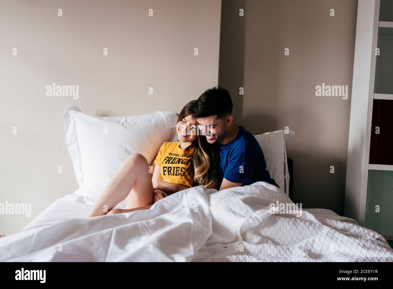 Smiling couple lying in bed Stock Photo