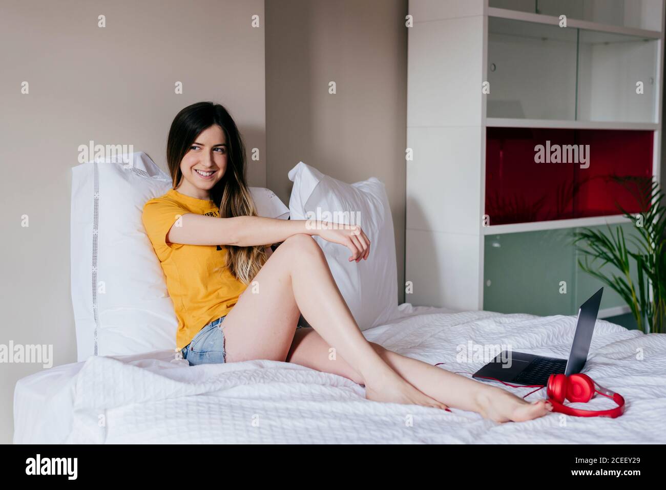 Pretty Woman lying on bed Stock Photo