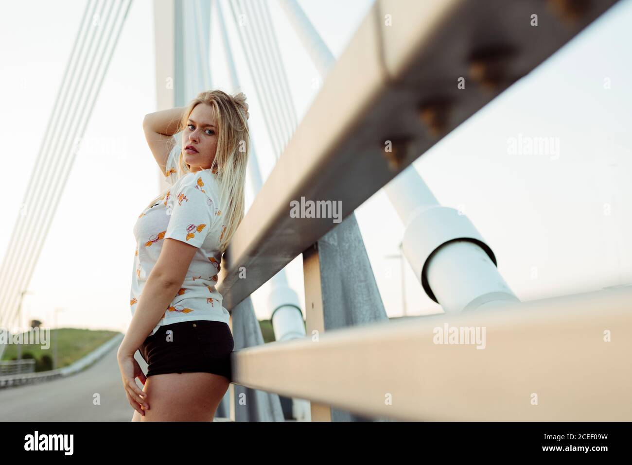 Young Woman standing on bridge Stock Photo