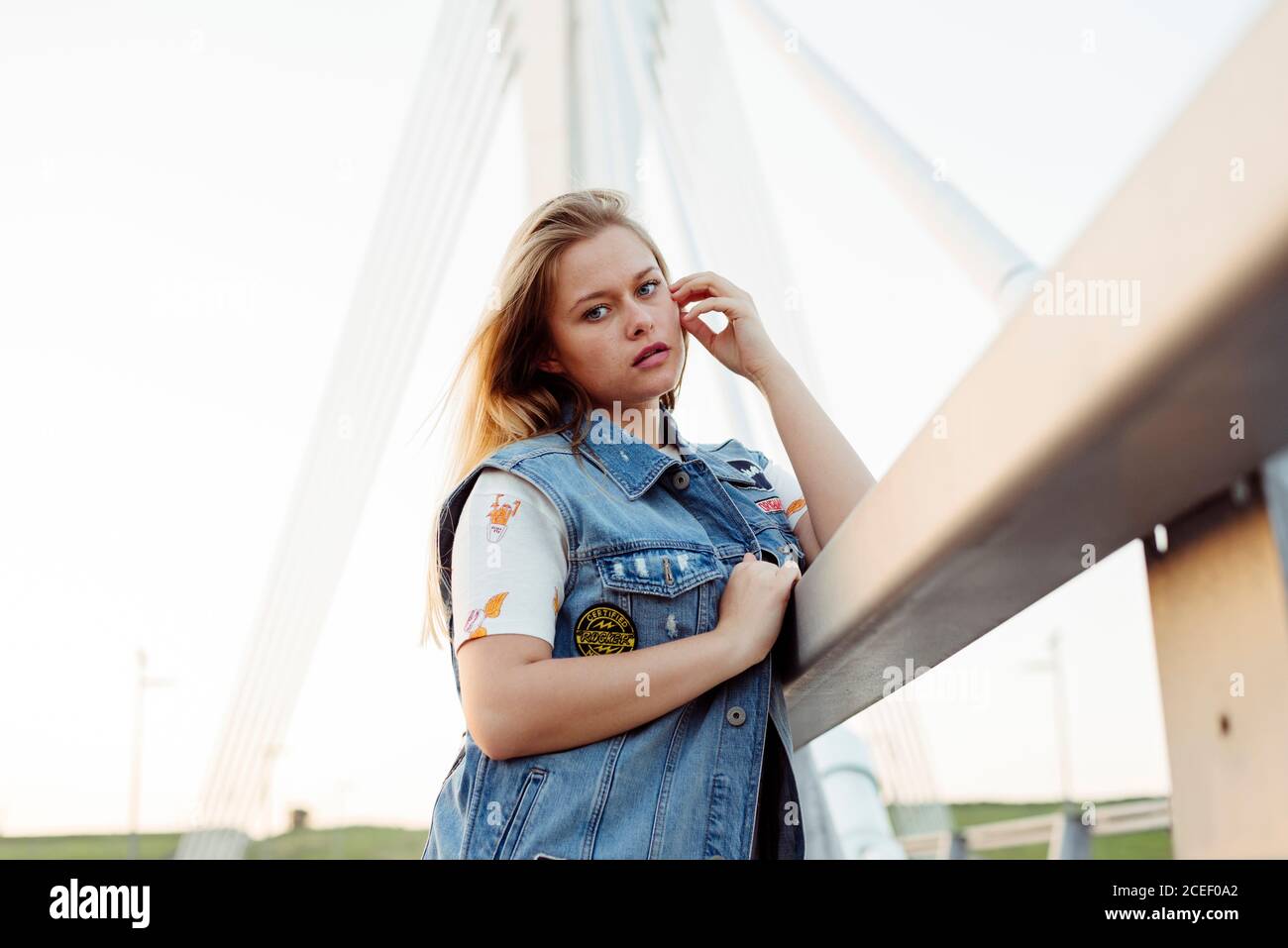 Young Woman standing on bridge Stock Photo