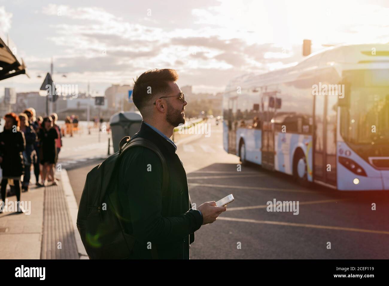 Stylish dreaming man with smartphone Stock Photo