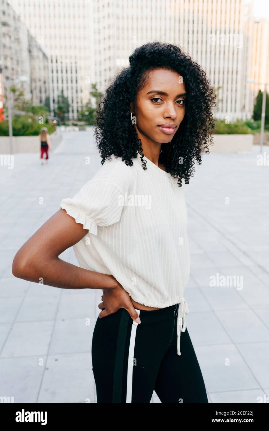 Laughing African-American Woman on street hands up Stock Photo