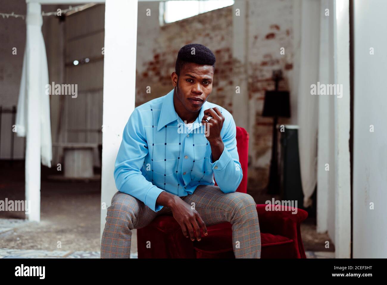 Elegant African-American man sitting on arm pad Stock Photo