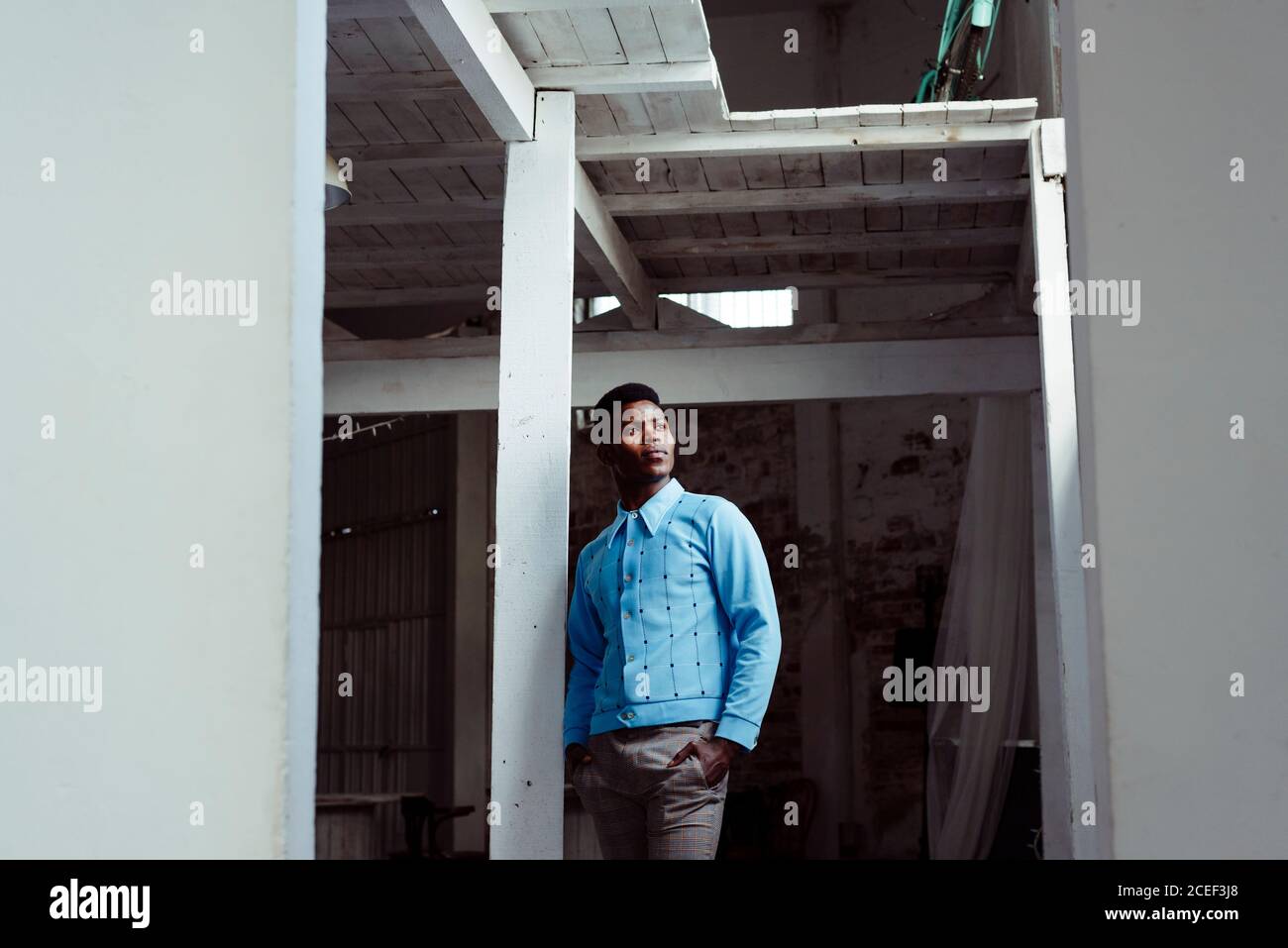 Stylish black man leaning on wall Stock Photo