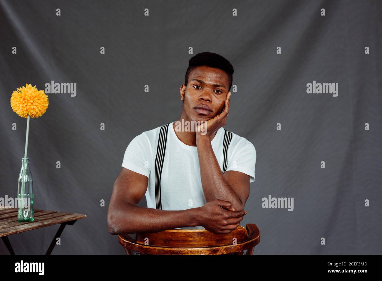 Stylish black man sitting near table Stock Photo
