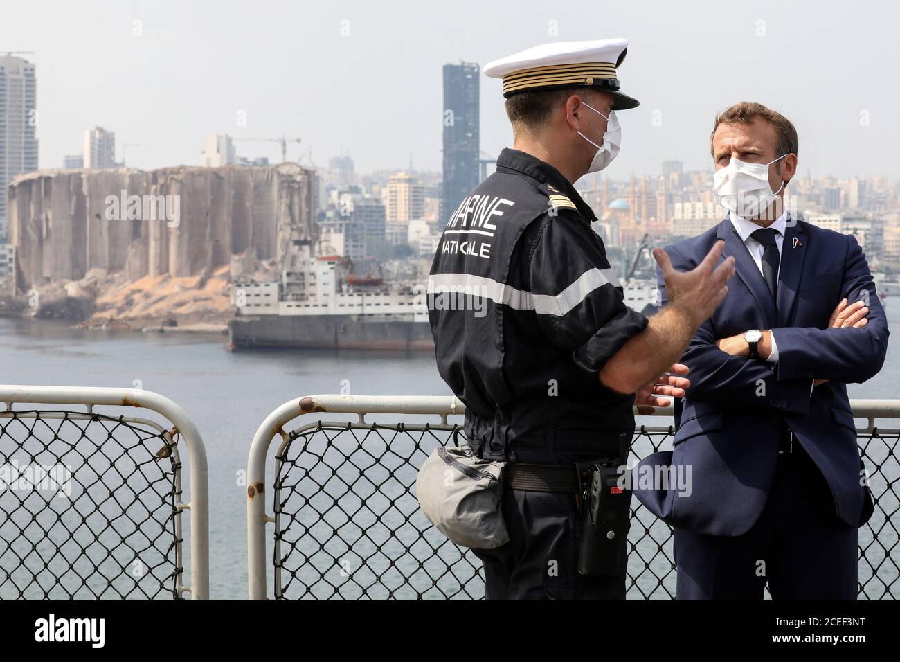 French President Emmanuel Macron speaks with Arnaud Tranchant, commander of the Tonnerre helicopter carrier, as he meets with UN representatives and NGOs mobilised for the reconstruction of the port of Beirut, in Beirut, Lebanon September 1, 2020. Stephane Lemouton/Pool via REUTERS Stock Photo