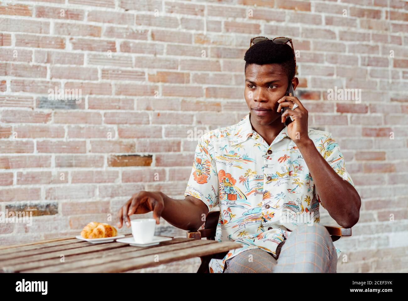 man using smartphone during breakfast Stock Photo