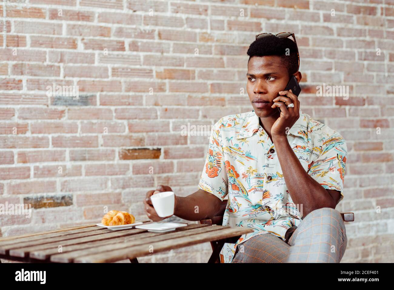 man using smartphone during breakfast Stock Photo