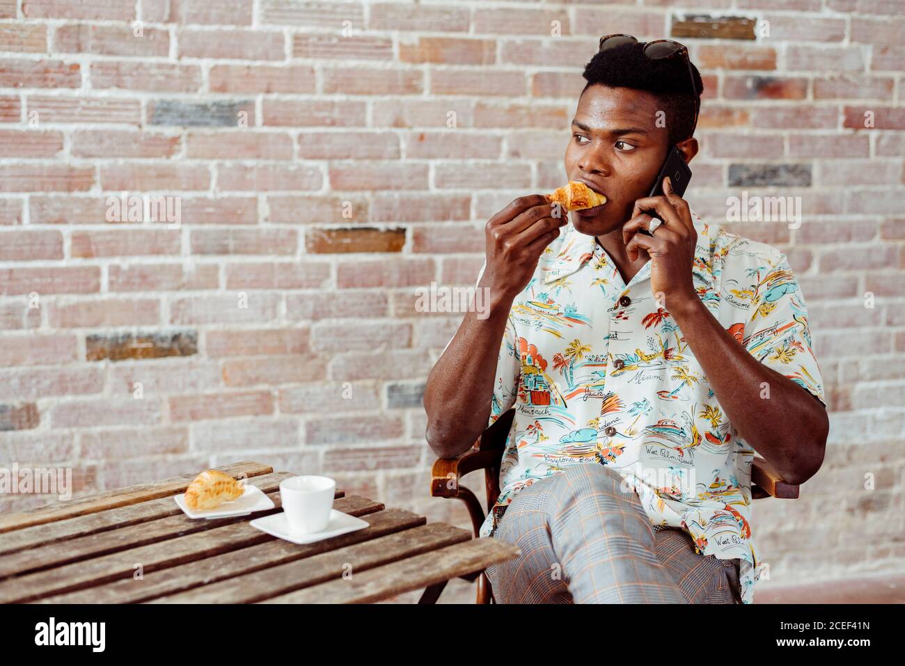 man using smartphone during breakfast Stock Photo