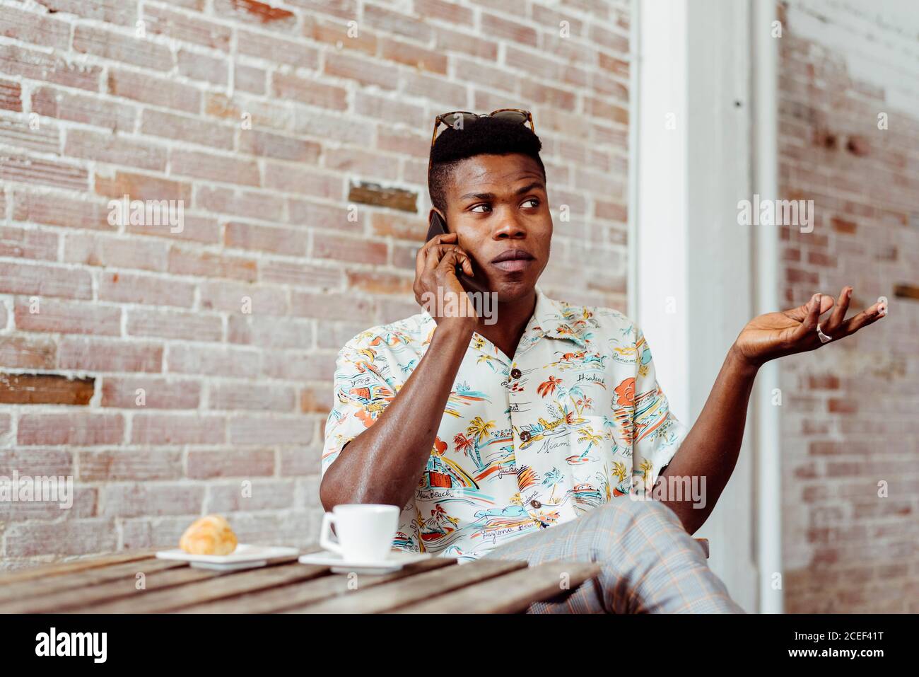 man using smartphone during breakfast Stock Photo