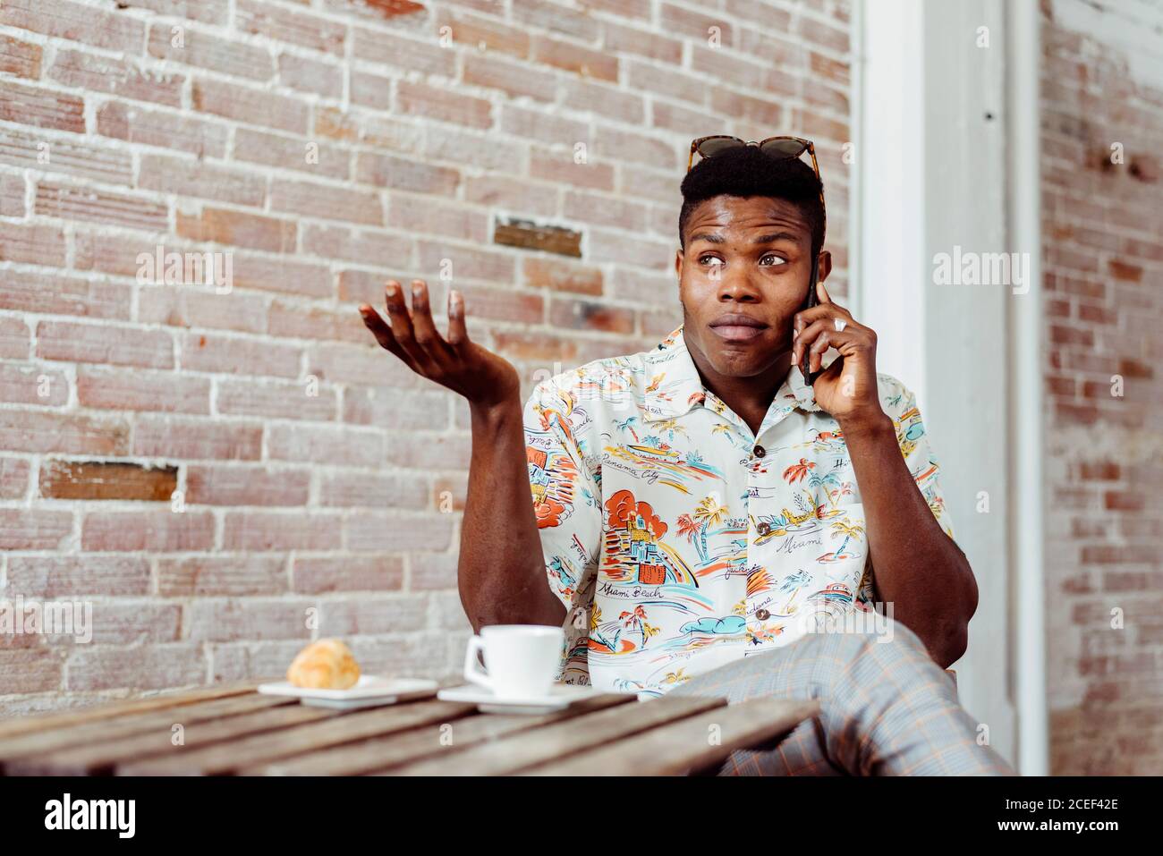 man using smartphone during breakfast Stock Photo
