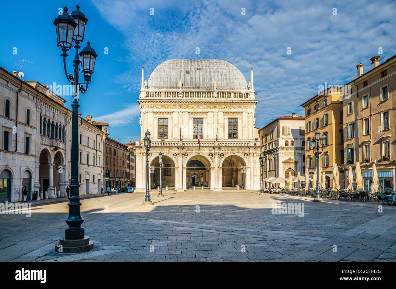 Palazzo della Loggia palace Town Hall Renaissance style building and street lights in Piazza della Loggia Square, Brescia city historical centre, blue sky background, Lombardy, Northern Italy Stock Photo