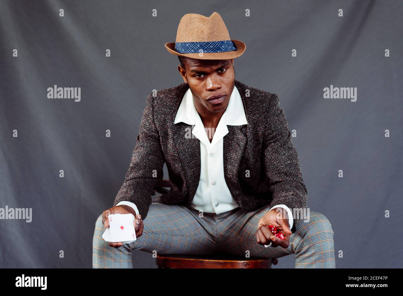 man with playing card throwing dices Stock Photo