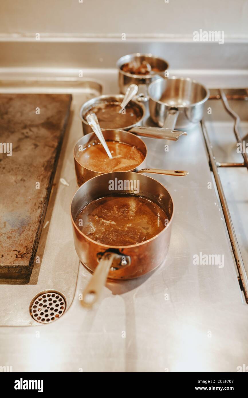 The different pots filled with the sauce on the restaurant kitchen from