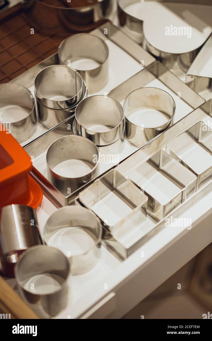 Different metallic utensils for dishes serving on cafe kitchen. Stock Photo