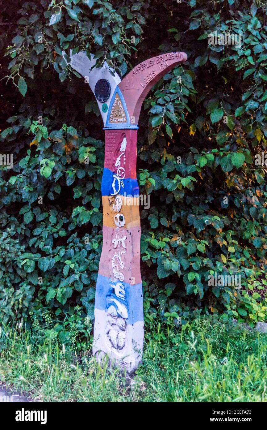 National Cycle Network painted milepost on the towpath of the Leeds- Liverpool Canal, Shipley, West Yorkshire, England Stock Photo