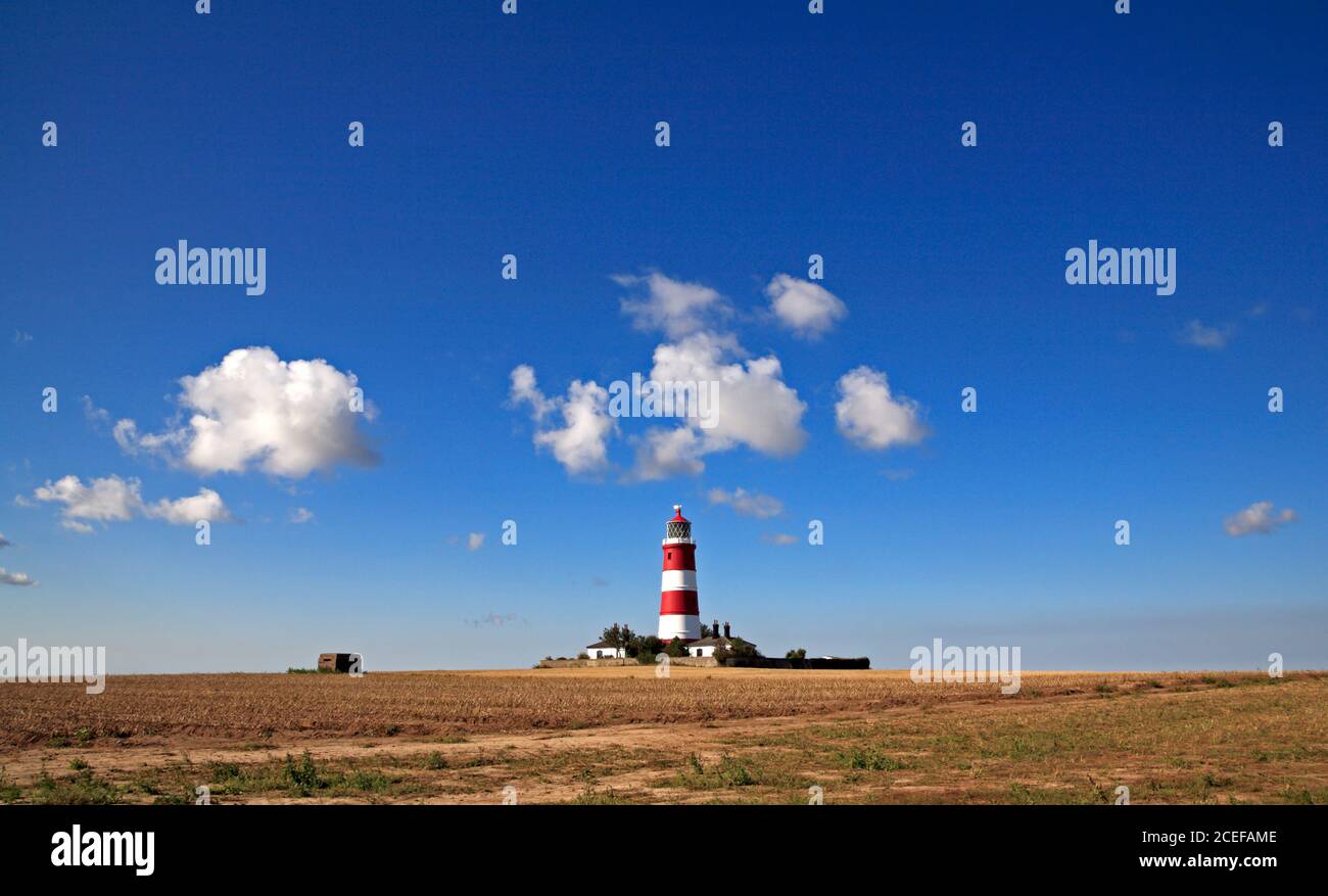 A view of the independently operated lighthouse against a blue sky with white clouds on the North Norfolk coast at Happisburgh, Norfolk, England, UK. Stock Photo