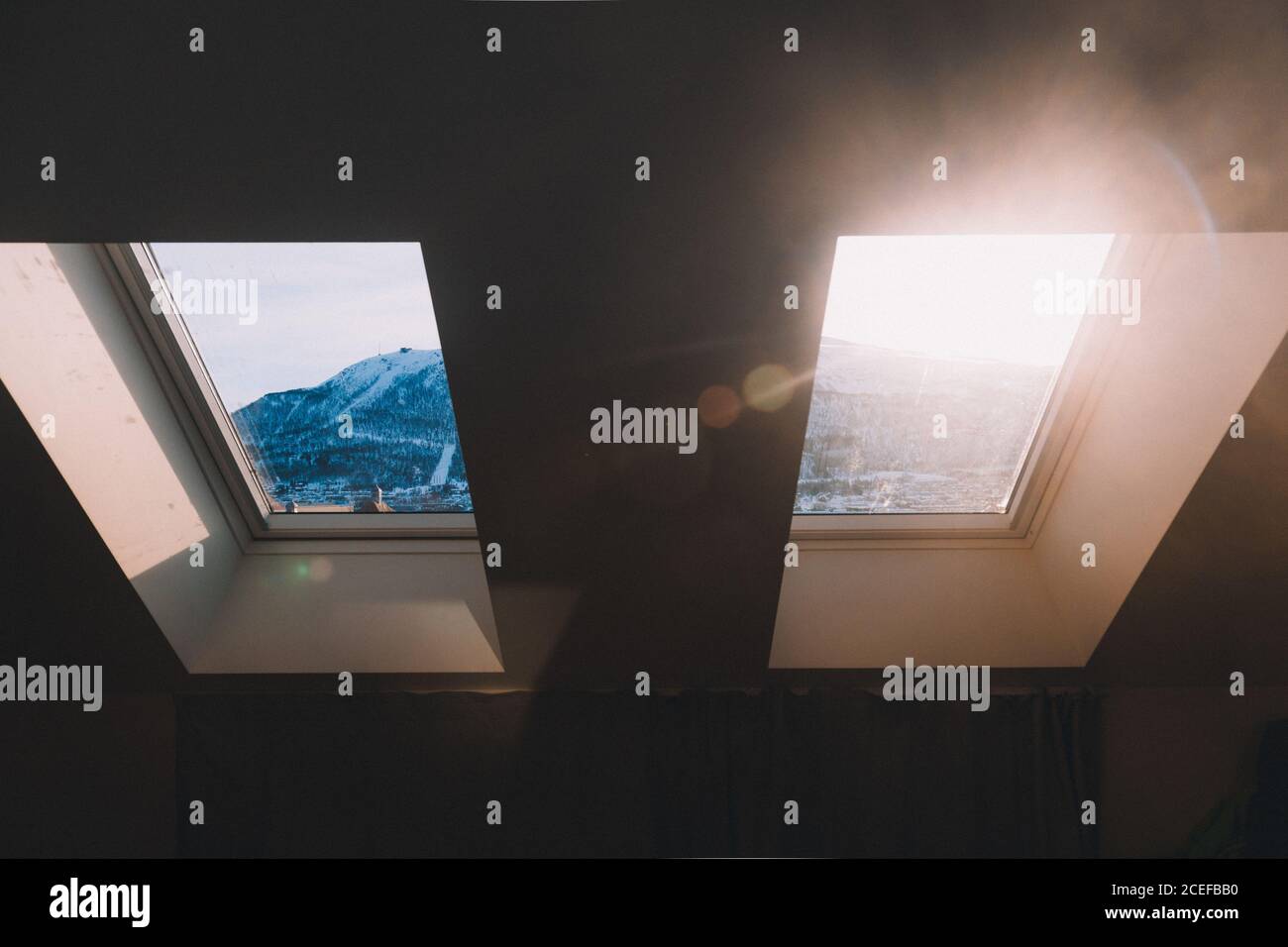 View of mountains through mansard window Stock Photo