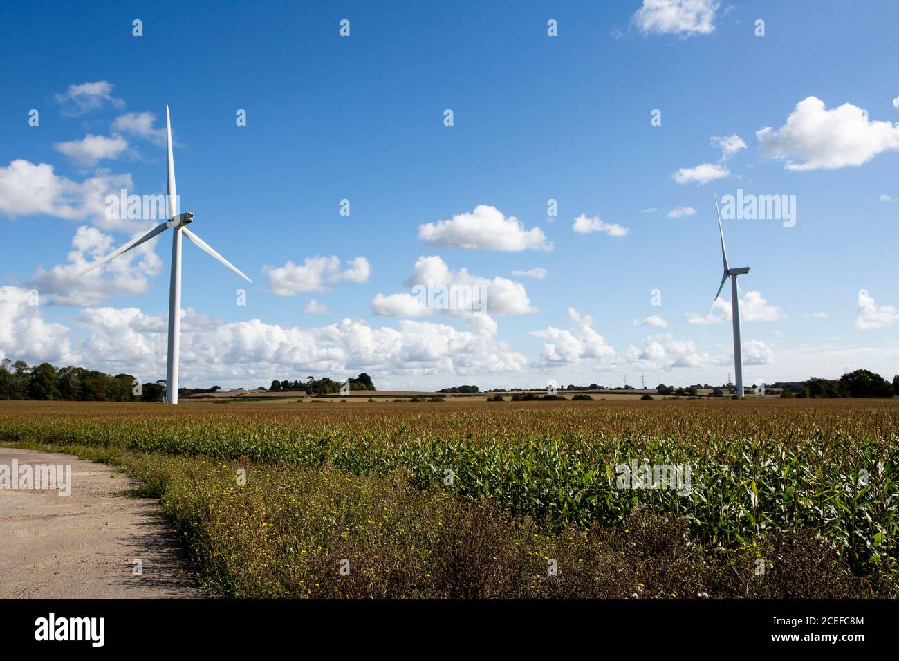 Wind Turbines against blue cloudy sky Stock Photo - Alamy