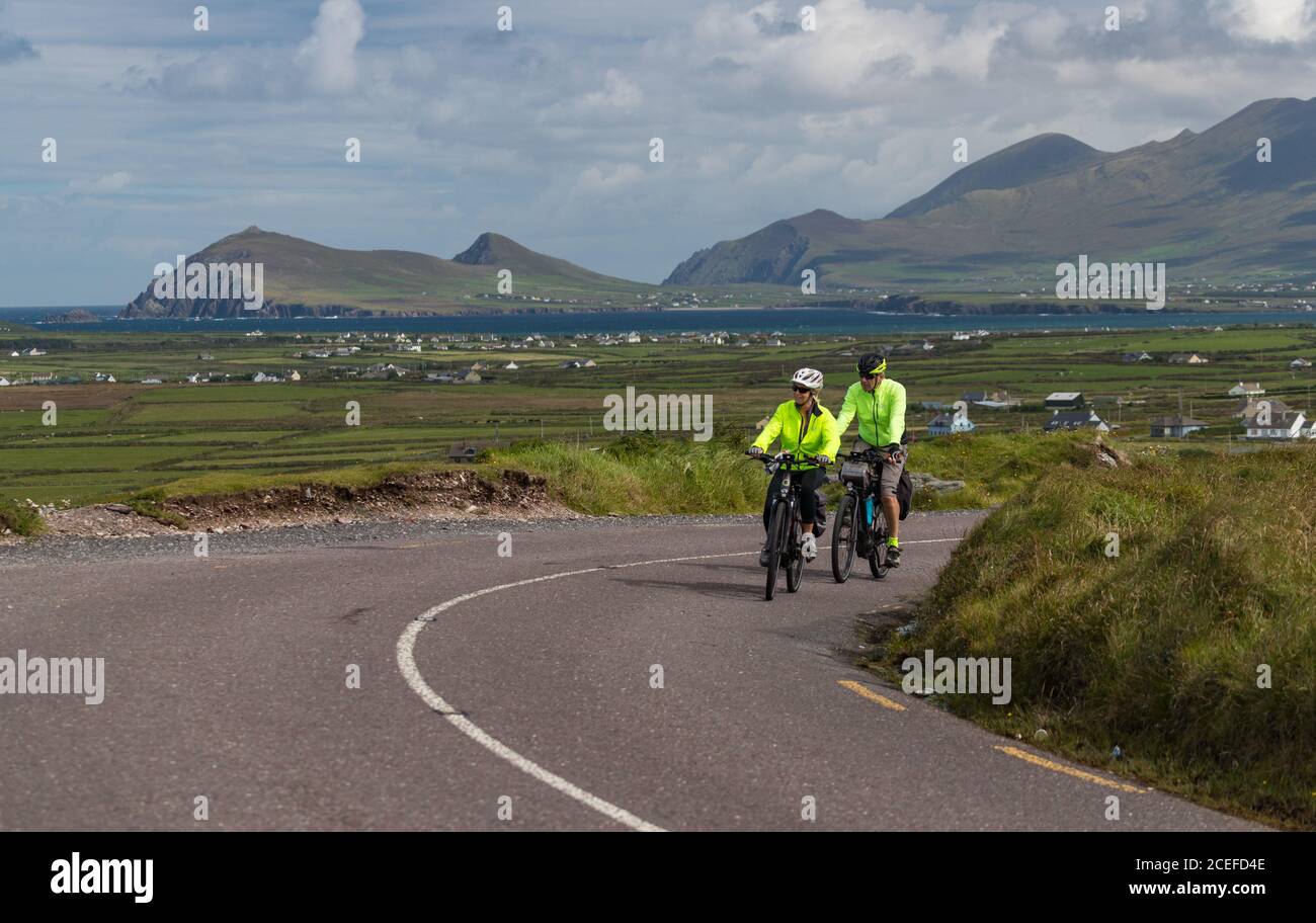 Dingle Peninsula, Ireland - 29th August 2020: Tourists cycling scenic Slea Head Drive on the Dingle peninsula, county Kerry on the west coast of the R Stock Photo