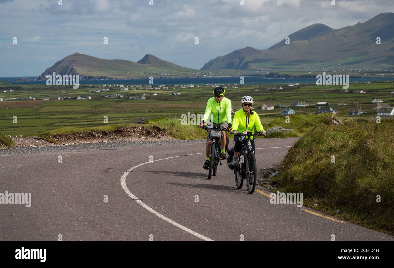 Dingle Peninsula, Ireland - 29th August 2020: Tourists cycling scenic Slea Head Drive on the Dingle peninsula, county Kerry on the west coast of the R Stock Photo