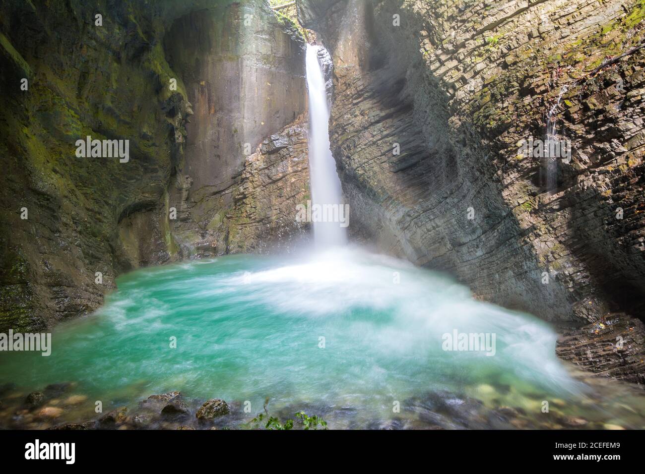 Beautiful waterfall between mountains with river with clean azure water ...