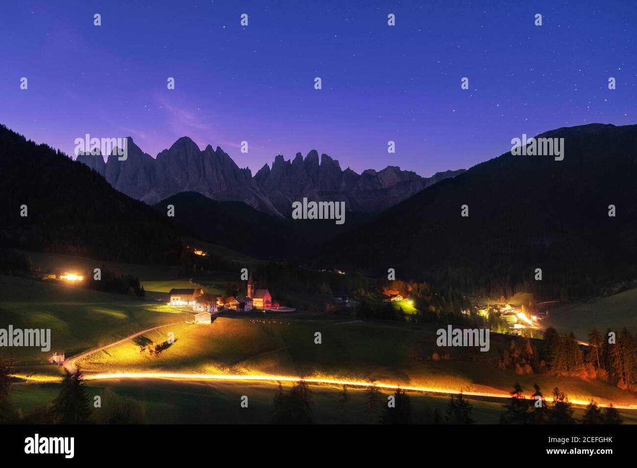 Night starry sky over Santa Maddalena village in Dolomites Alps, Italy Stock Photo
