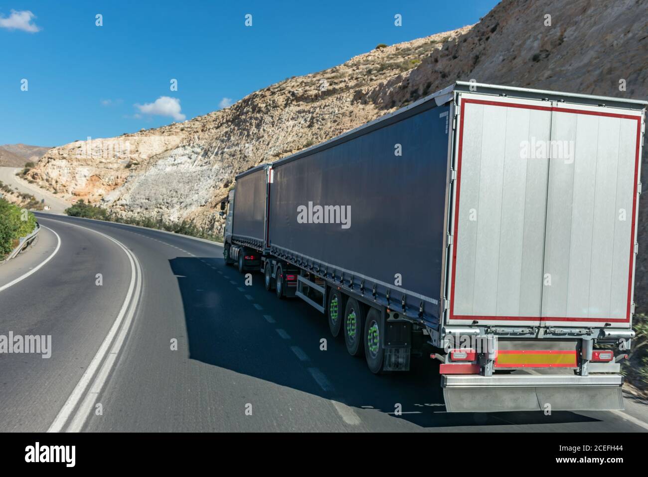 Mega trailer or road train, truck with two semi-trailers authorized to transport sixty tons. Stock Photo