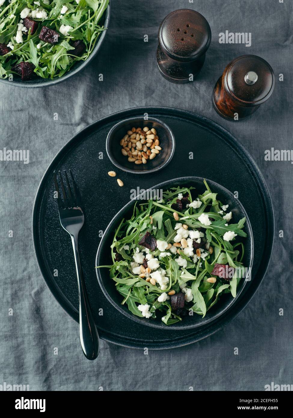 Beetroot, aragula and soft cheese salad over gray linen tablecloth. Top view or flat lay. Stock Photo