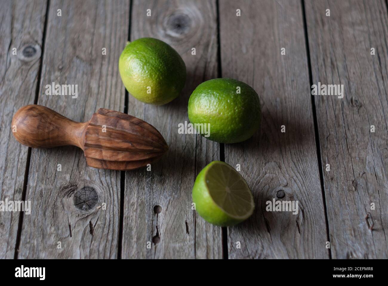 Delicious limes with manual citrus juicer Stock Photo Alamy