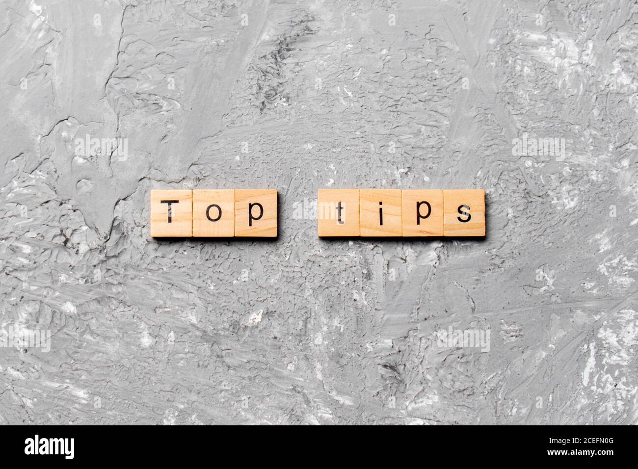 Top tips word written on wood block. Top tips text on cement table for