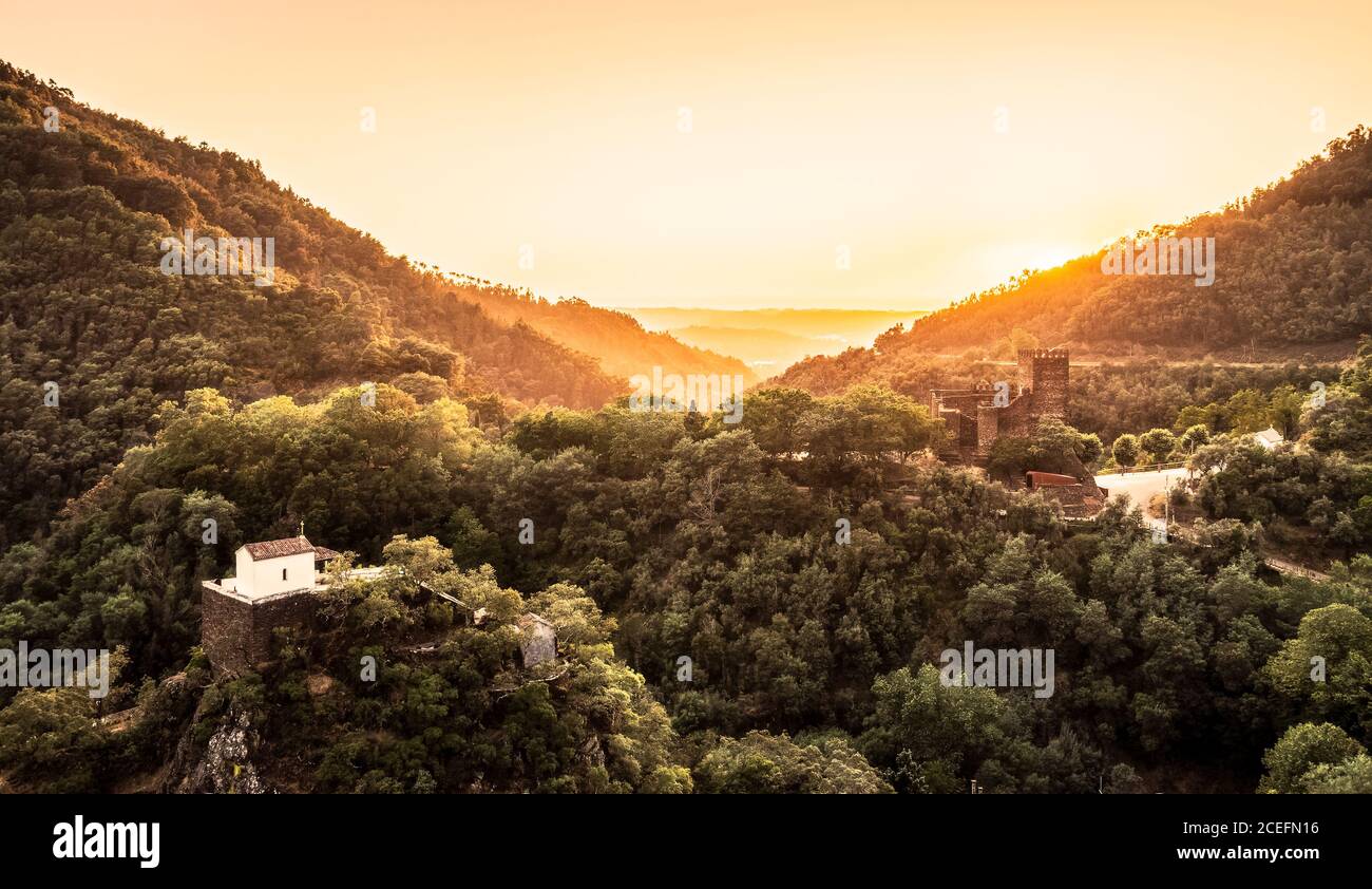 Panoramic view of the Chapel of Nossa Senhora da Piedade and the castle of Lousã, in Portugal, with a wonderful sunset. Stock Photo