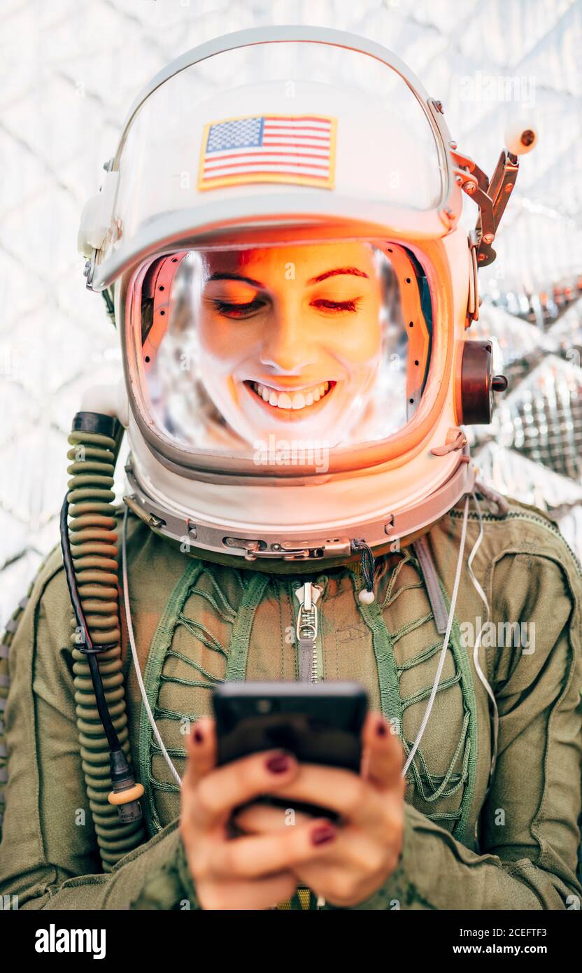 Beautiful female astronaut with mobile phone. Stock Photo