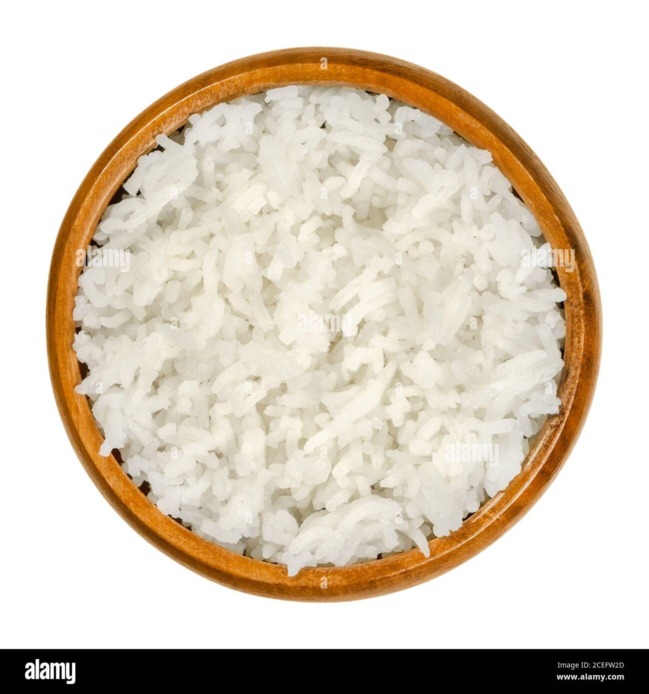 Cooked white basmati rice in a wooden bowl. Rice variety with long slender grains and aromatic smell and taste, from the Indian subcontinent. Stock Photo