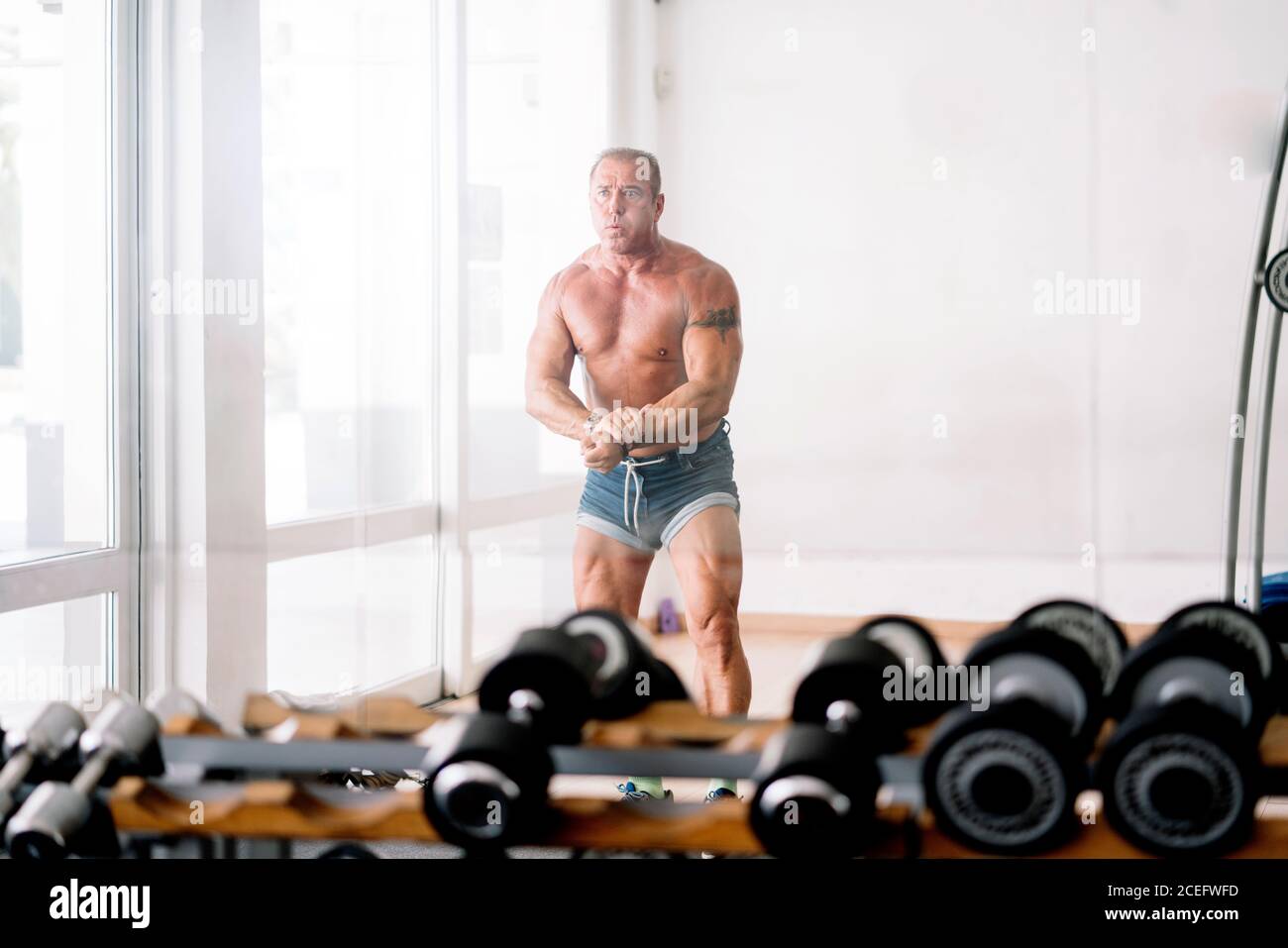 Muscular older man posing Stock Photo - Alamy