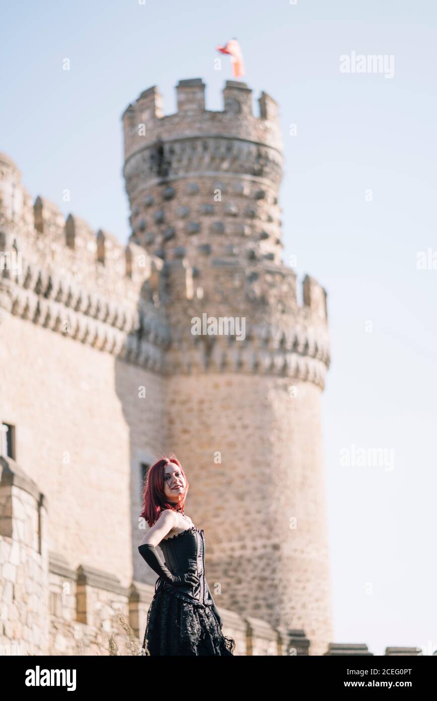 Pretty red haired medieval girl poses together castle Stock Photo - Alamy