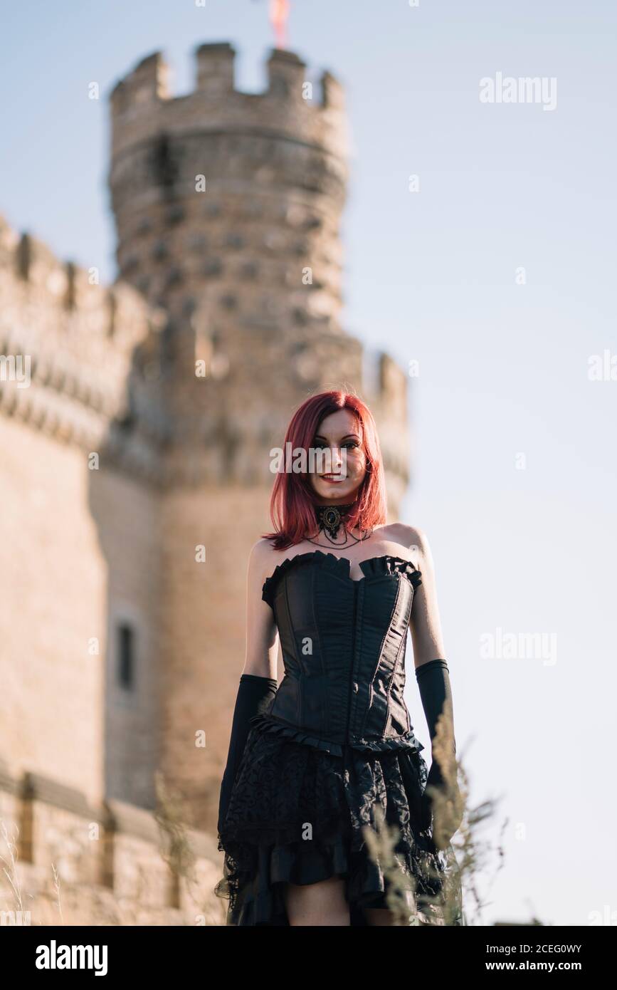 Pretty red haired medieval girl poses together castle Stock Photo - Alamy