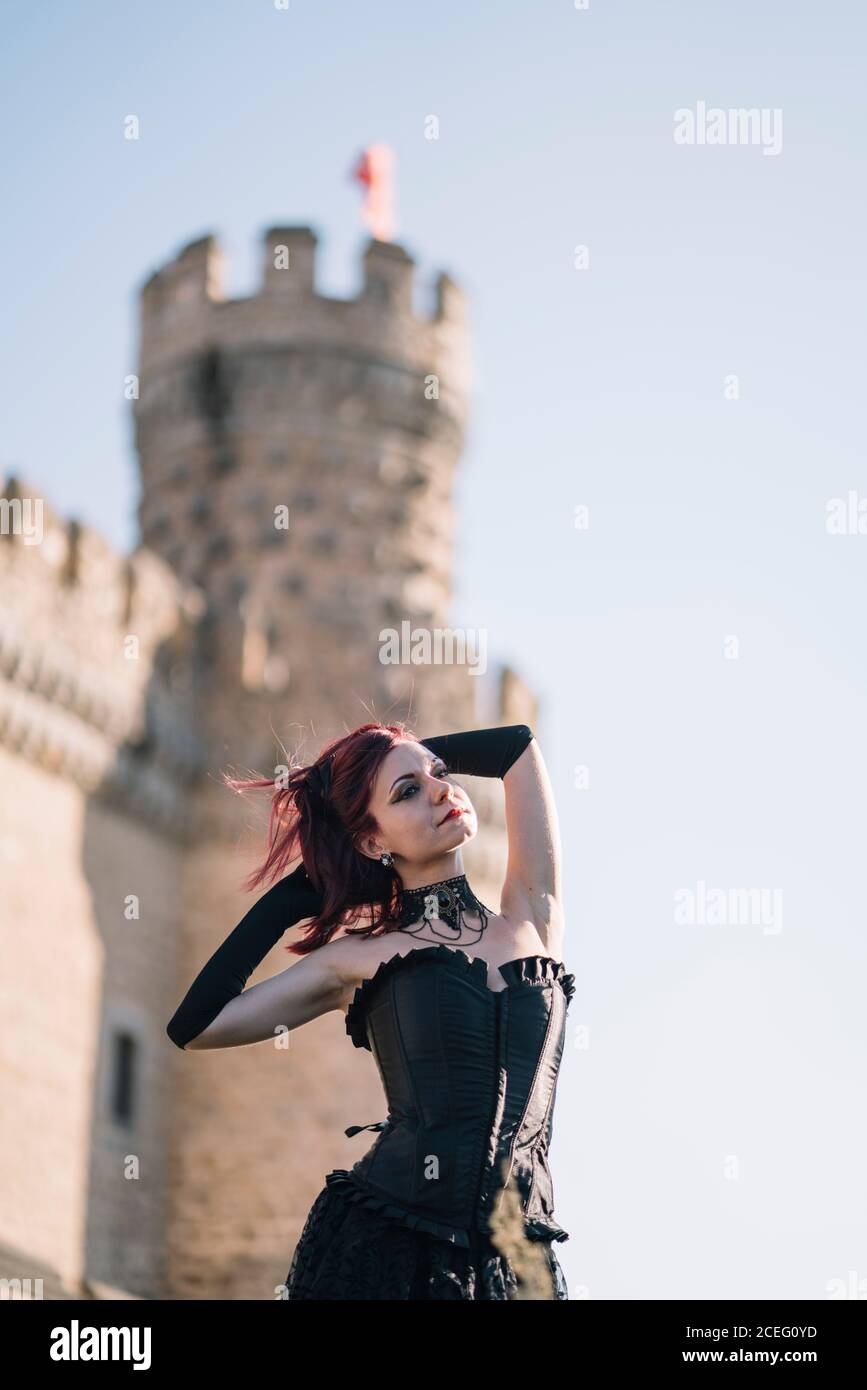 Pretty red haired medieval girl poses together castle Stock Photo - Alamy