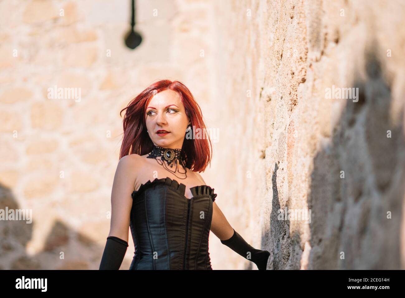 Pretty red haired medieval girl poses together castle Stock Photo - Alamy