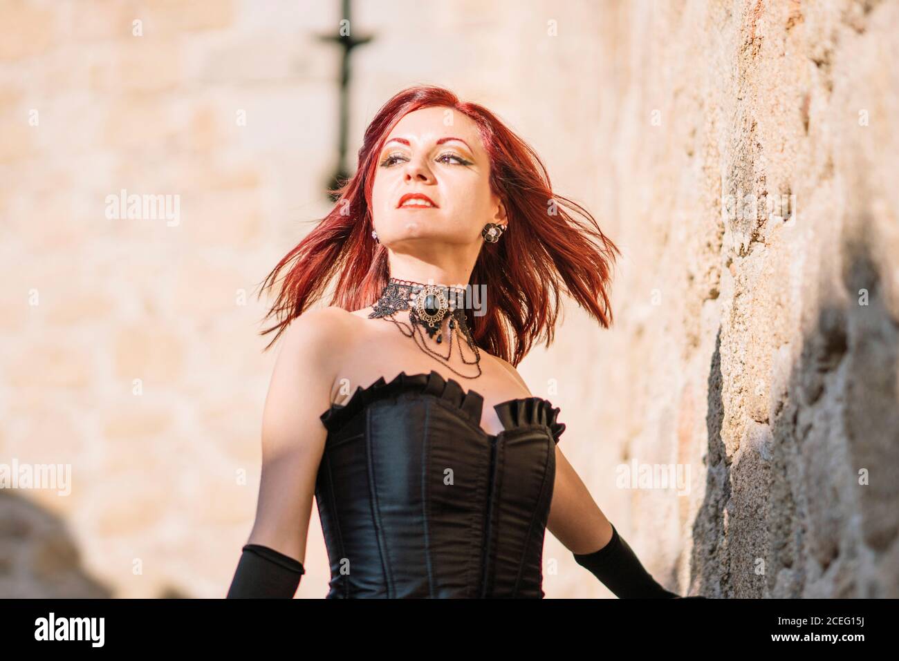 Pretty red haired medieval girl poses together castle Stock Photo - Alamy