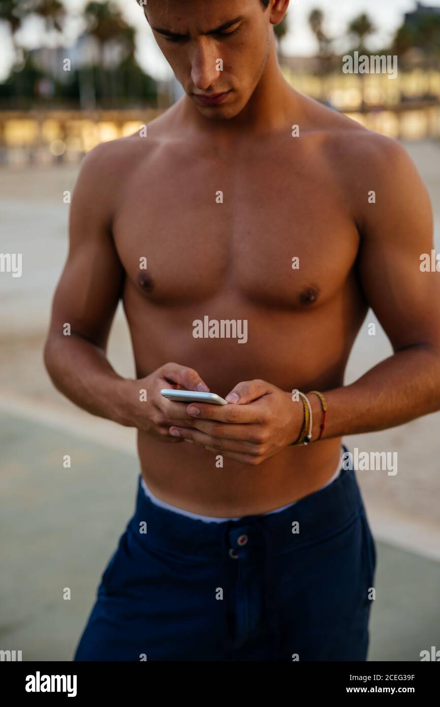 Athlete man training outdoors with mobile. Stock Photo