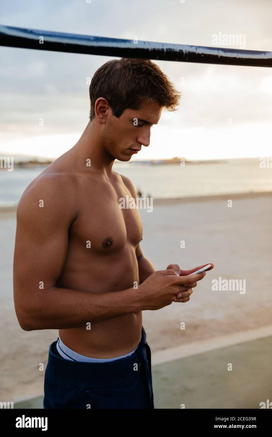 Athlete man training outdoors with mobile. Stock Photo
