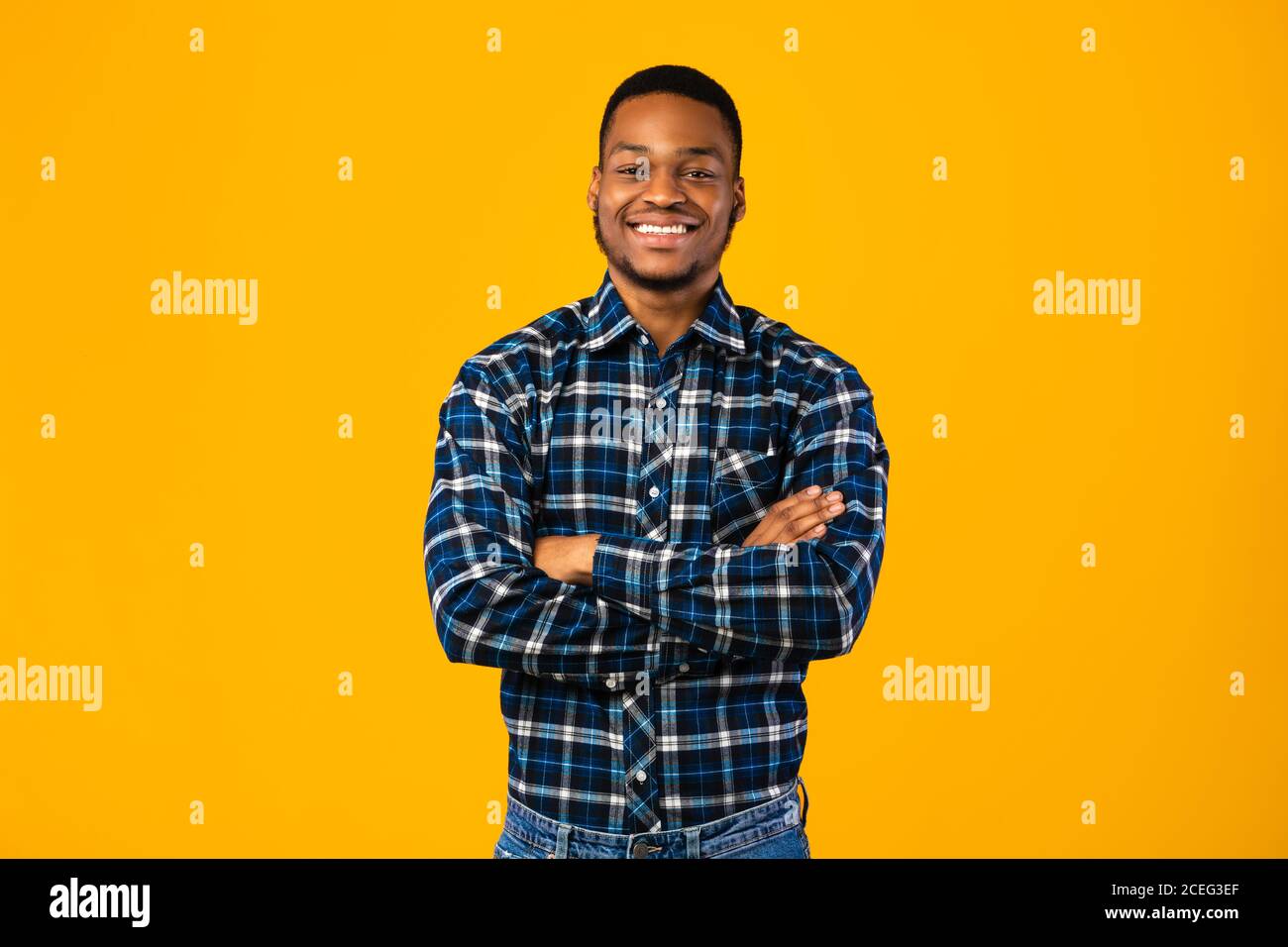 Black Man Posing Crossing Hands Standing In Studio Stock Photo