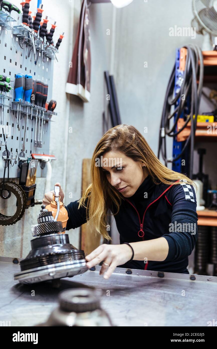 Woman working in a mechanical workshop Stock Photo