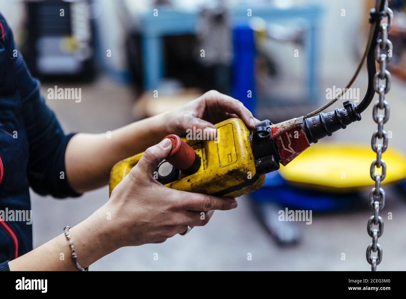 Woman with tools in a mechanical garage Stock Photo