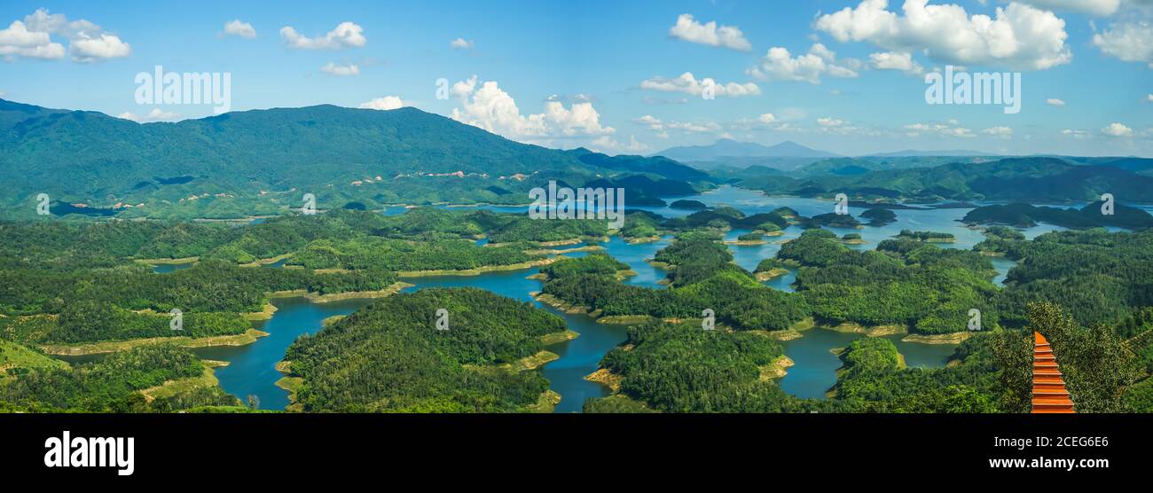 Ta Dung lake in the summer. Blue sky and cloudy on the lake and the trees on the small island paradise. Dak Nong global geological park, Dak Nong prov Stock Photo