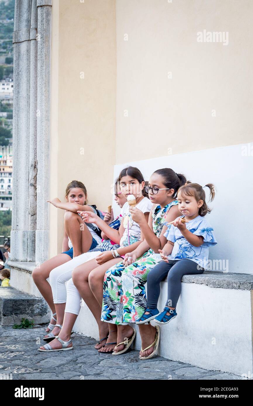 Cute children on holiday enjoy tasty ice creams in Ravello Town Sq, Italy. Stock Photo